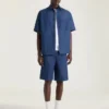 Bermuda en denim avec coutures couture et tampon Givenchy Bermuda en denim avec coutures couture et tampon Givenchy