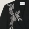 Veste à double boutonnage fendue en laine avec paillettes Veste à double boutonnage fendue en laine avec paillettes